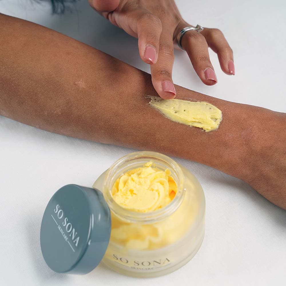 Applying nourishing body butter on skin